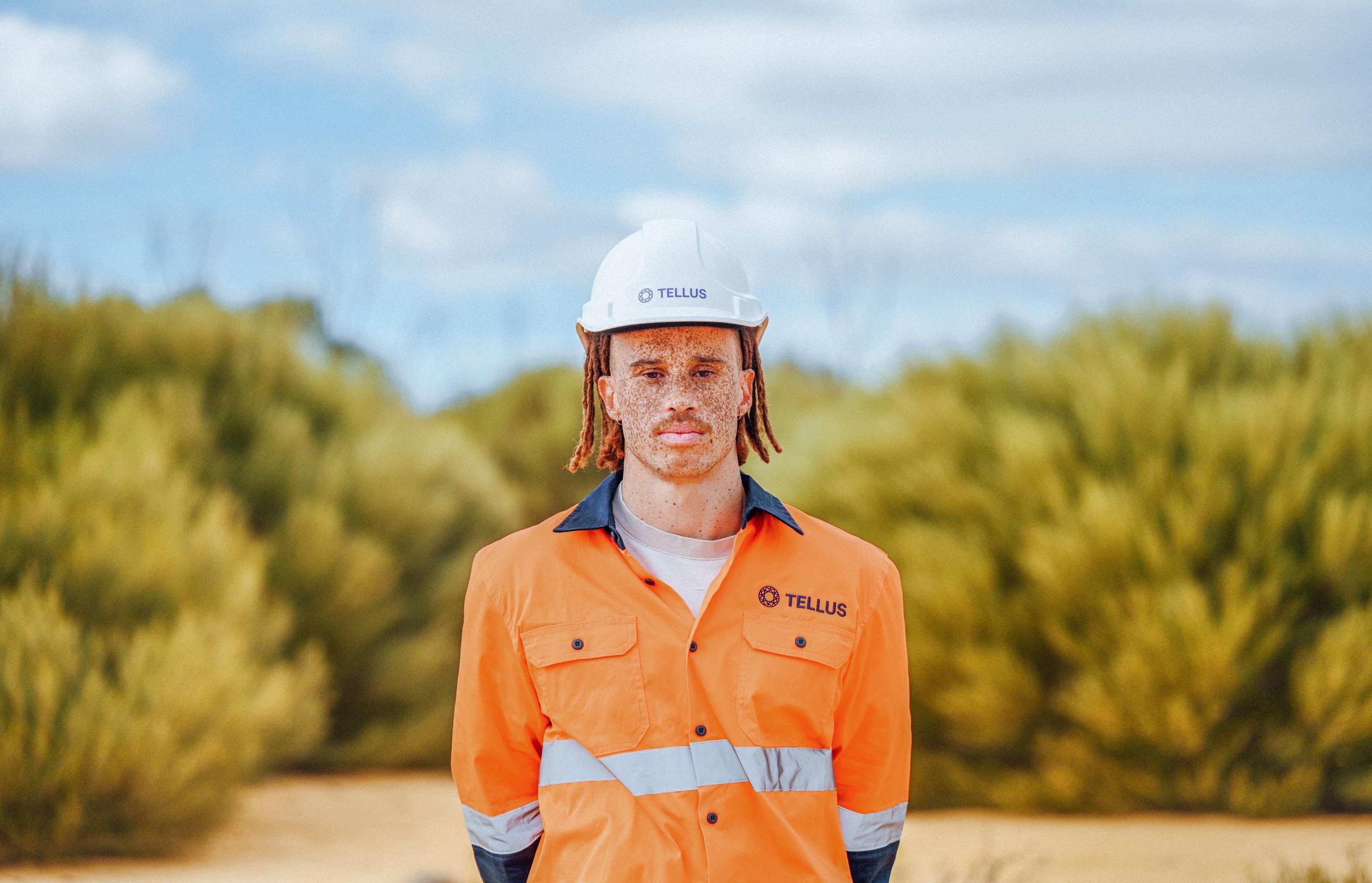 Image is of a career as a FIFO employee at Sandy Ridge. Tellus employee wears personal protective clothing and equipment and looks ready to create a cleaner, greener Australia. 