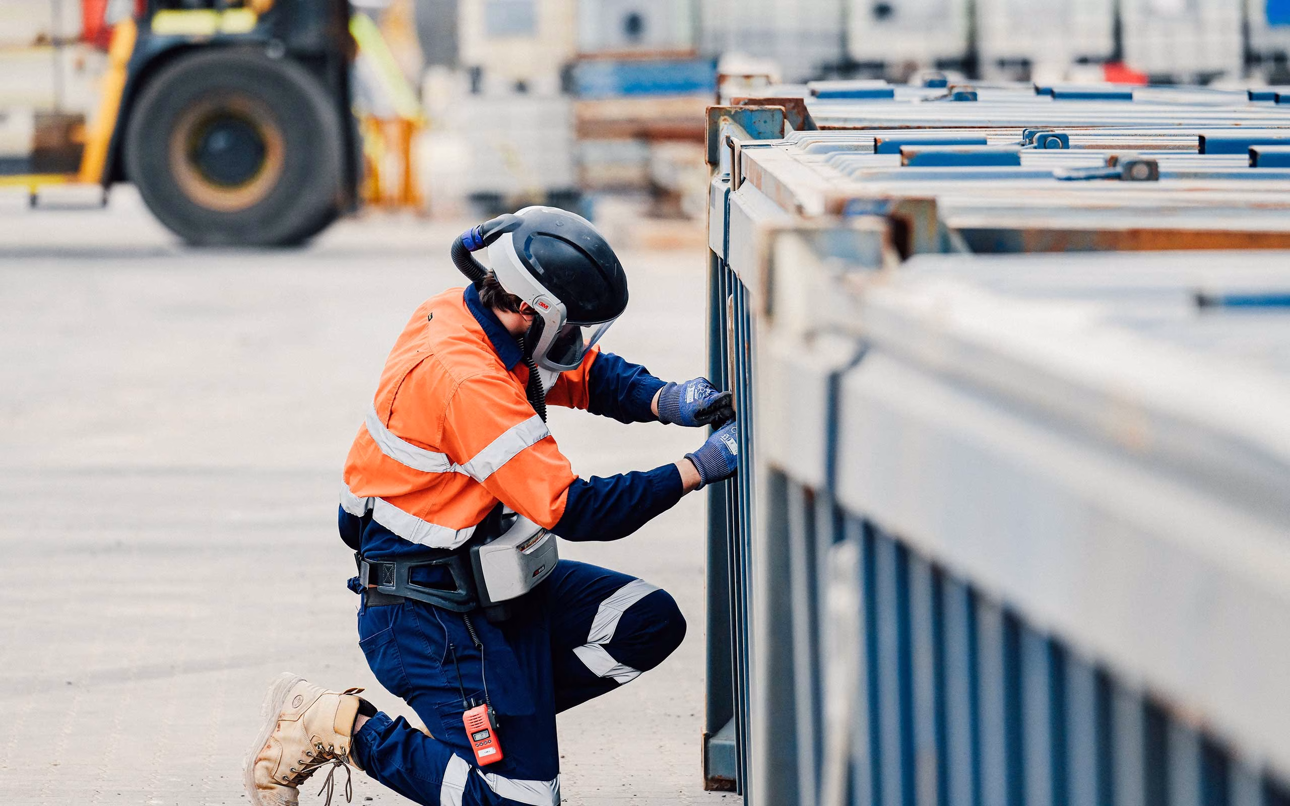 Image is of a diligent employee at the Tellus Sandy Ridge sustainability precinct. The employee is using the highest standard of personal protective clothing and equipment while working in the waste receivals yard. The image represents how Tellus provides end-to-end sustainable solutions for almost all hazardous waste types and industries.